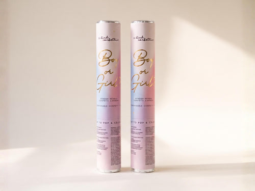 Two Boy or Girl gender reveal confetti cannons standing upright in soft directional light